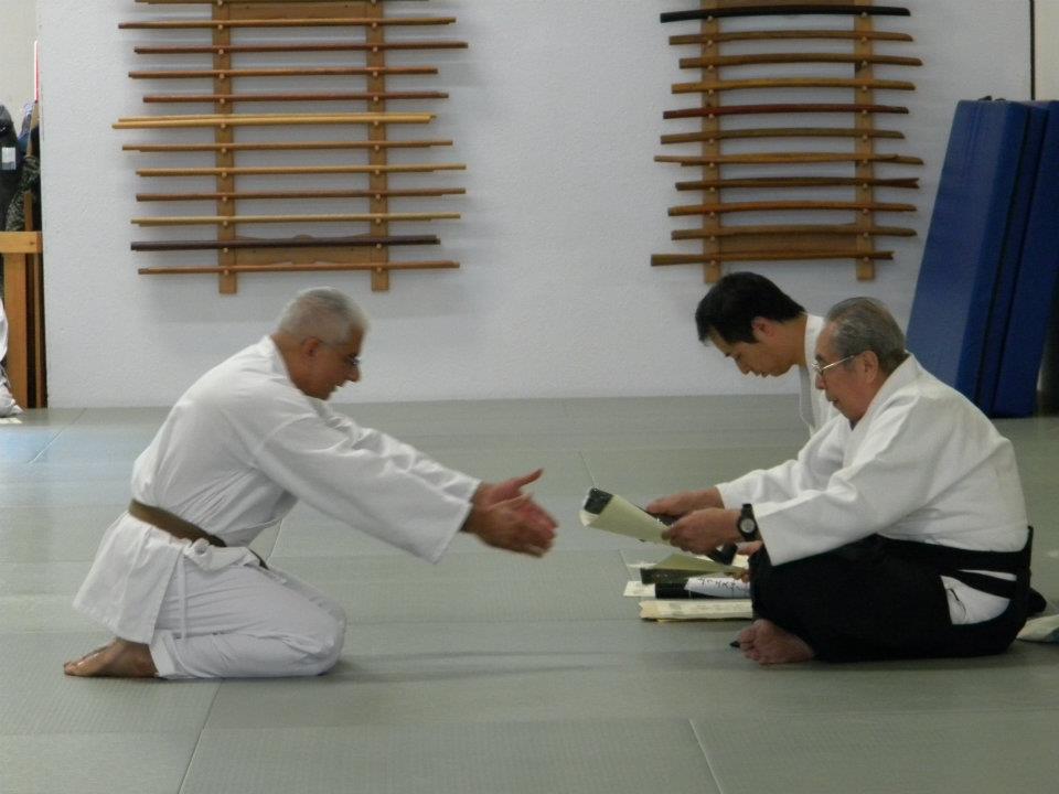 Dr. Aiki (Jaideep Sensei) receiving Shodan certificate (black belt) in the art of Roppokai from Soshi Okamoto
